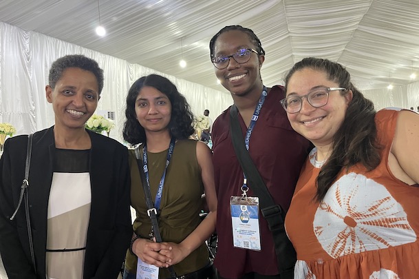 Students pose with a conference attendee