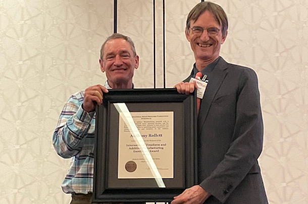 Rollett poses receiving award with Joe Beaman