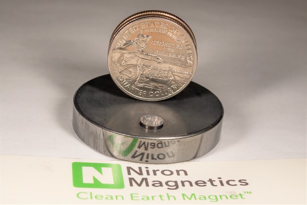 Magnet shown with quarter for scale