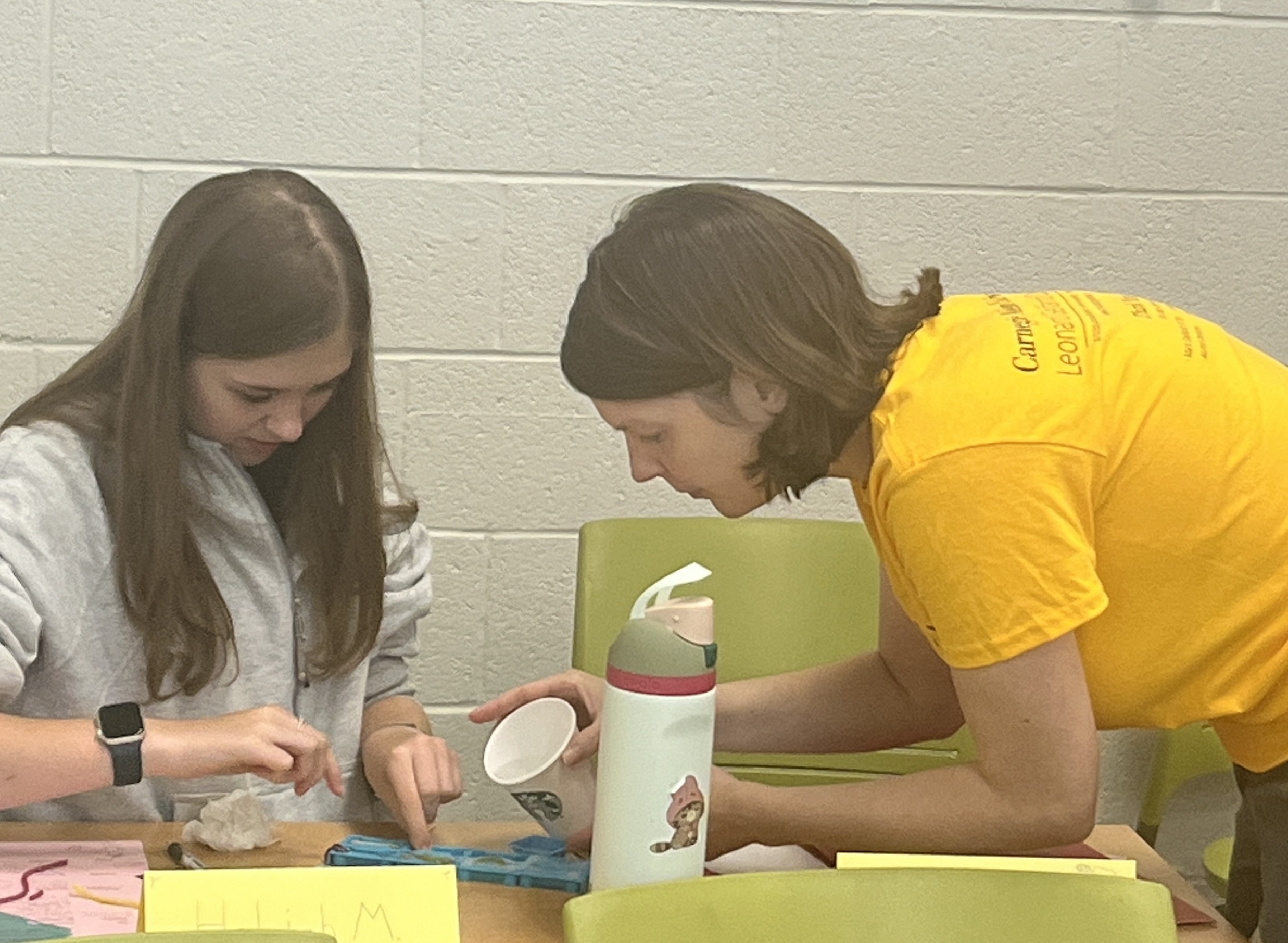 Mandie Krause assisting middle school student with experiment