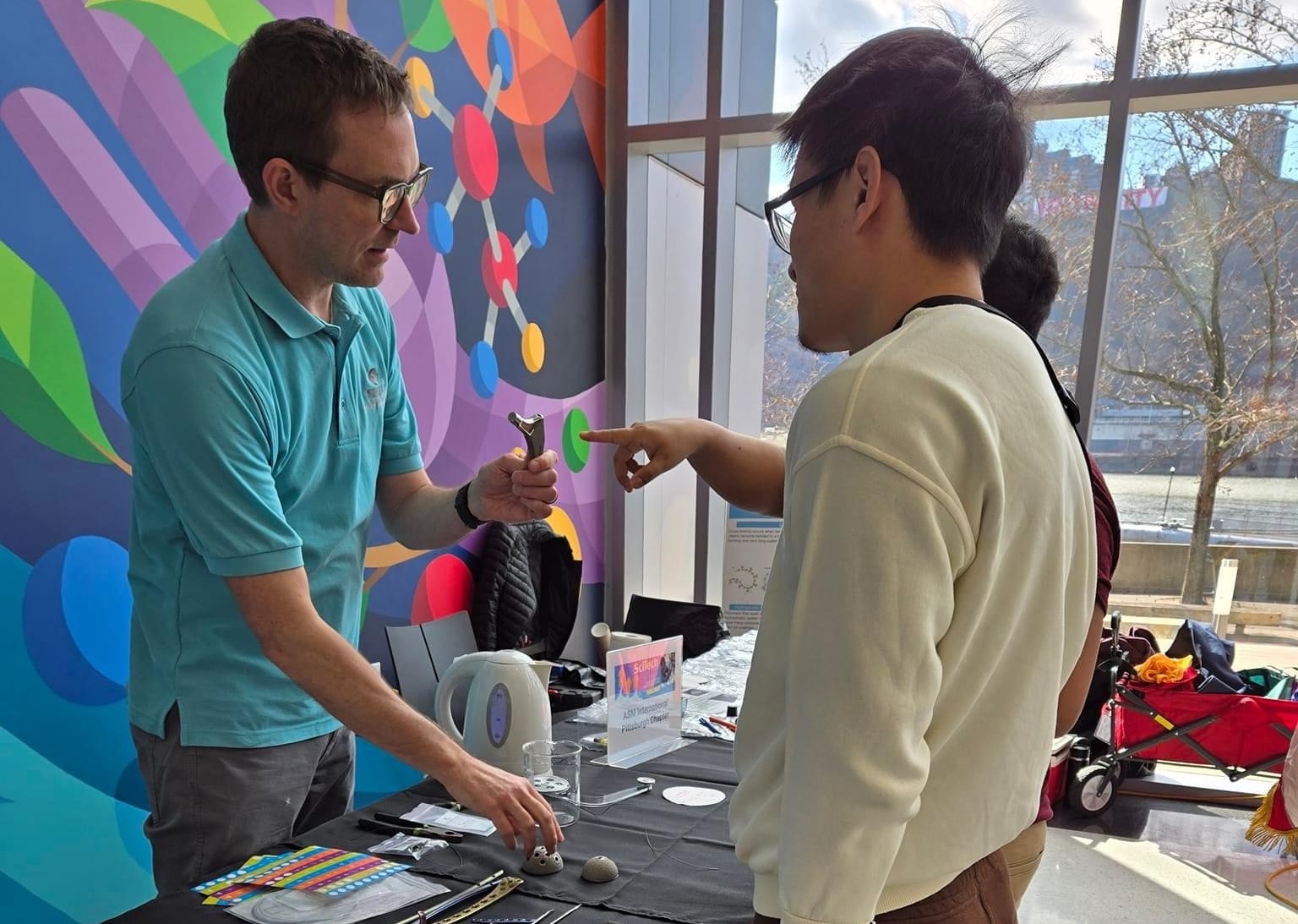 Justin Sickles talking to event attendee at Science Center