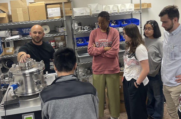 Students listening to speaker in lab space