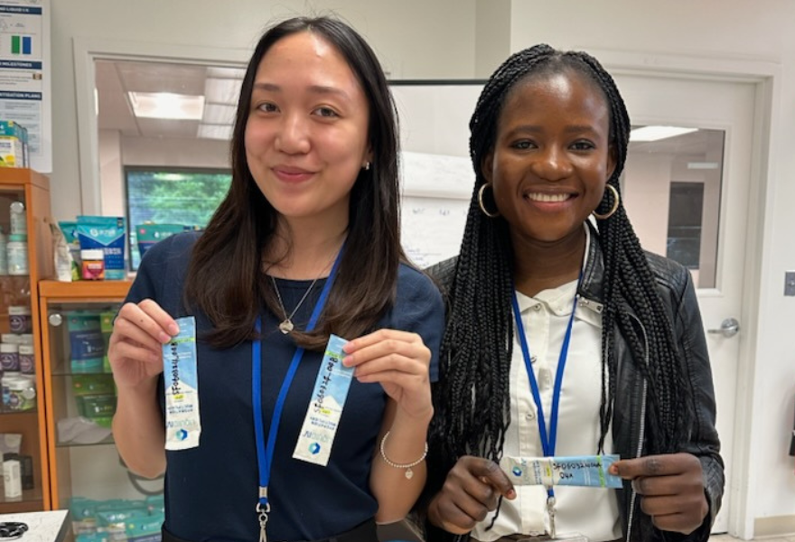 Isabelle and another intern holding liquid IV packets