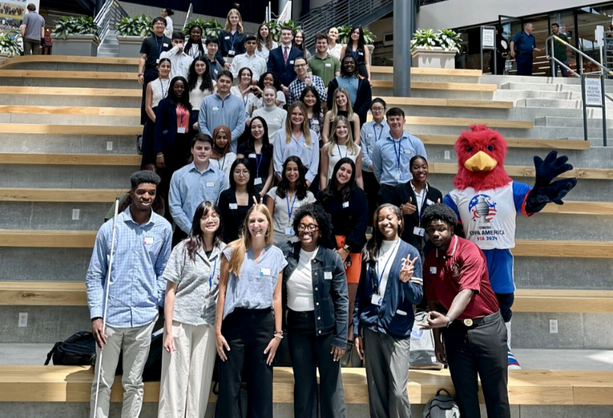 group photo of interns standing outside on steps