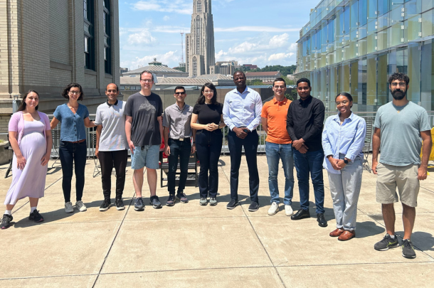 Dabo and members of his research group standing outside on CMU campus