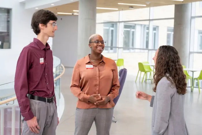 group of three students talking