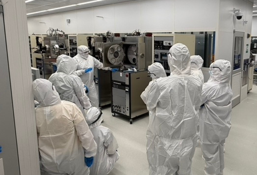 People in nanofabrication lab wearing clean suits